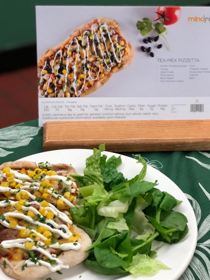 The school cafeteria is offering healthier options such as Tex-Mex pizza this year. 