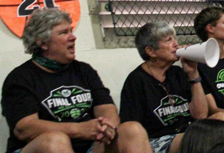 M Club members support the team during a basketball game.