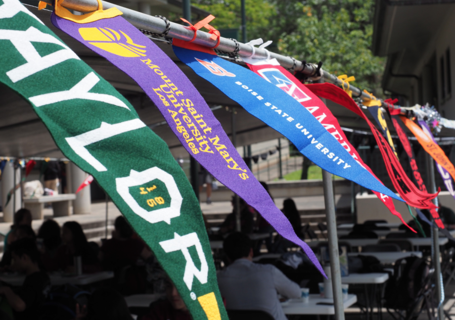 The banners of different colleges blow in the wind in unison during Mid-Pacific's 2019 college signing day. Current seniors are finding that the college application process is changing due to COVID-19. 
