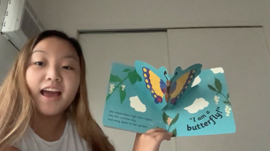 Senior and Interact Club president Alyssa Chun reading a children's book aloud in a video.The Interact Club participated in a service project where they read aloud in a video for kids to access on Hawaii Literacy's Instagram.