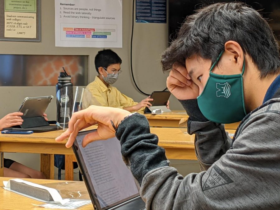 Freshman Junsei Tanizaki concentrates on his assignments as in Christopher Falks English Humanities class. Final exams for semester 1 were cancelled this school year due to the virtual learning program and COVID-19.