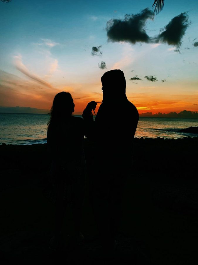 Couple Kapuaanhuea Robinson and her boyfriend cuddle together as they enjoy the sunset. High school dating life has been affected by the pandemic.