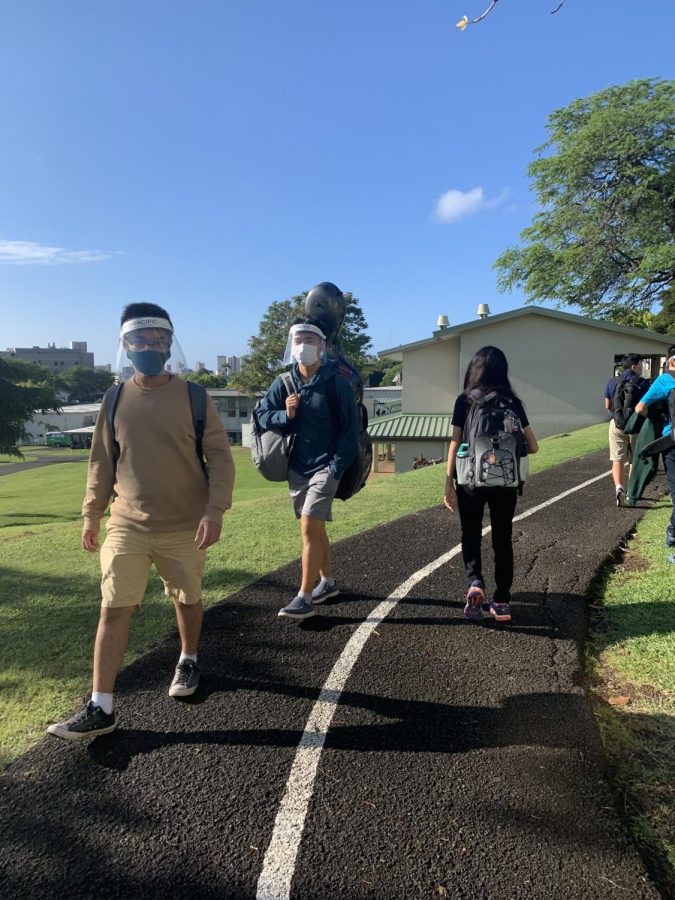 Students following path guidelines while wearing their face shields and mask as they approach their class. The Mid-Pacific community provided their perspective on how this school year has played out.