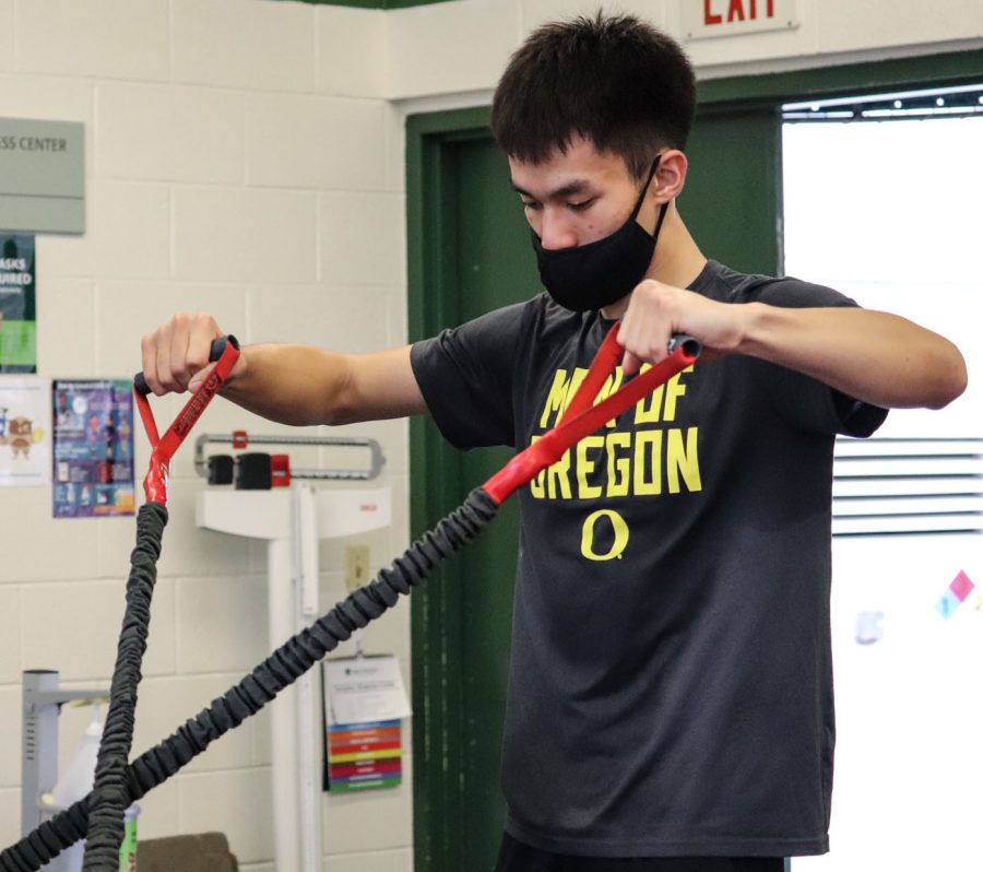 Senior Jordan Lee sweats as he works out in the weight room.