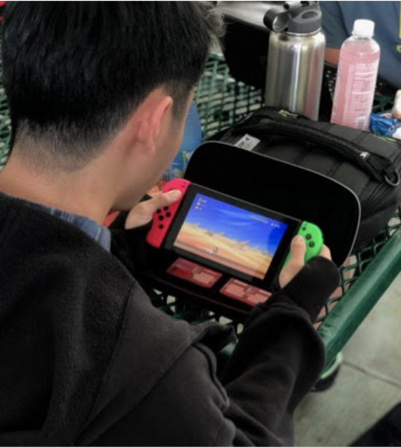 Michael Tam, an 11th grader plays on the Nintendo Switch last year. Increased screen time has made some people question whether teenagers are in front of their screens too much.