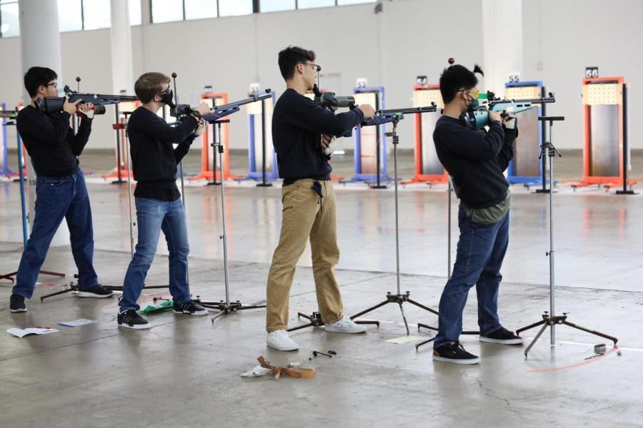 Nathan Loo, Ethan Harrison, Jordan Lampitelli, and Colby Fujino focus in their standing positions as they get ready to release the trigger on their rifles. The boy varsity air riflery team participated and won the Hawaii High School Athletic Association state championship.