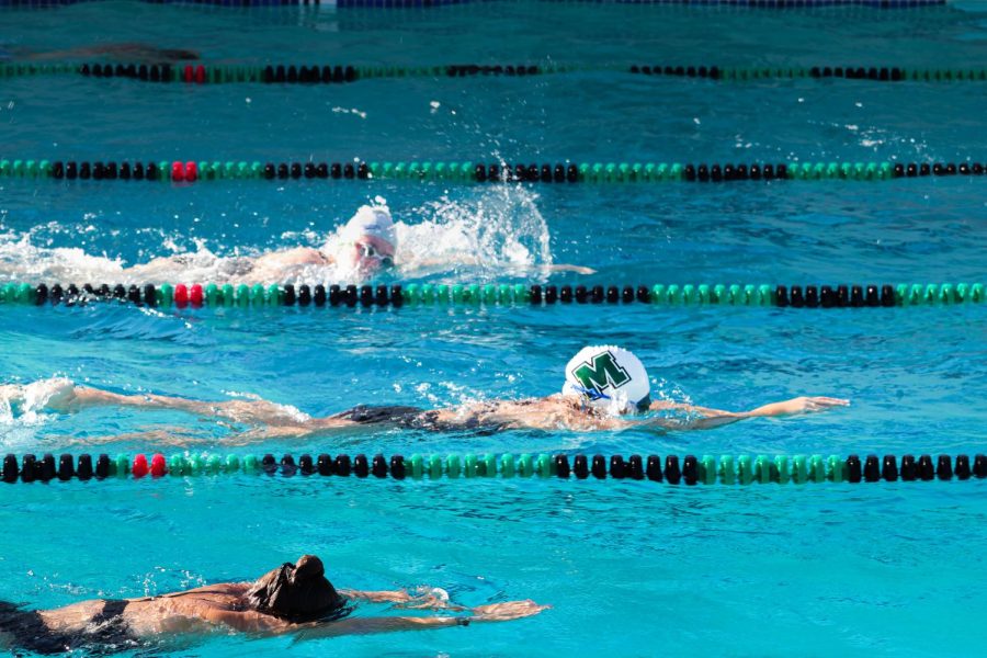 Girls' varsity team perform the freestyle stroke.