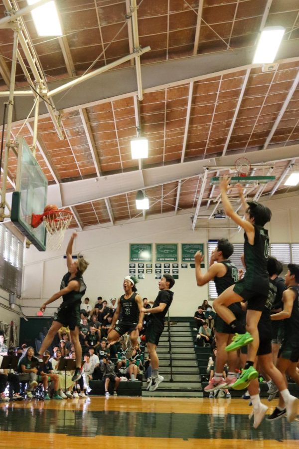 Boys+Basketball+Player+Rye+Nicholson+23+dunks+the+ball+while+his+team+cheers+him+on.