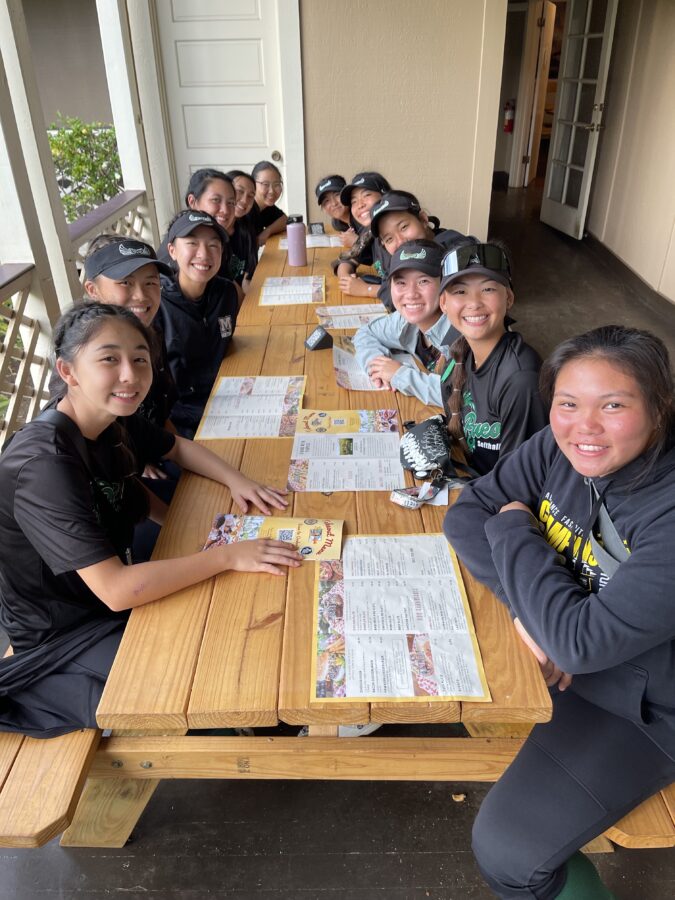 The Mid-Pacific varsity softball team enjoys their team bonding.