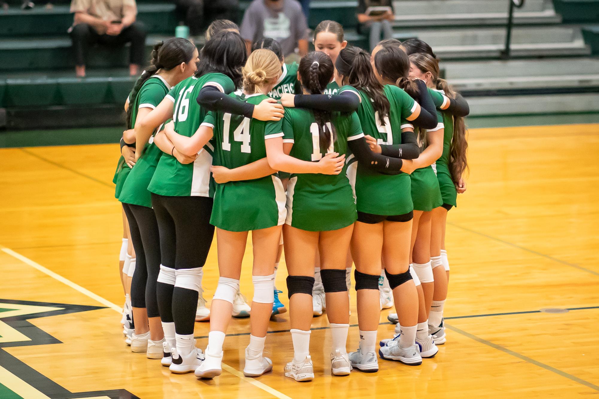 Mid-Pacific Girls volleyball team huddles after a match 