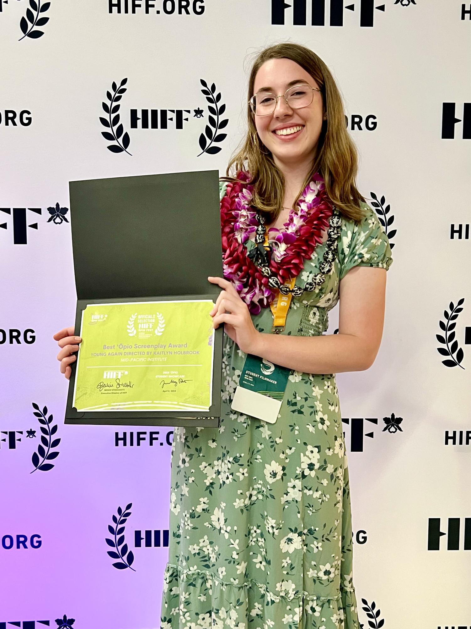 Kailey Holbrook posing with HIFF Award for Best 'Ōpio Screenplay Award for her directed film Young Again