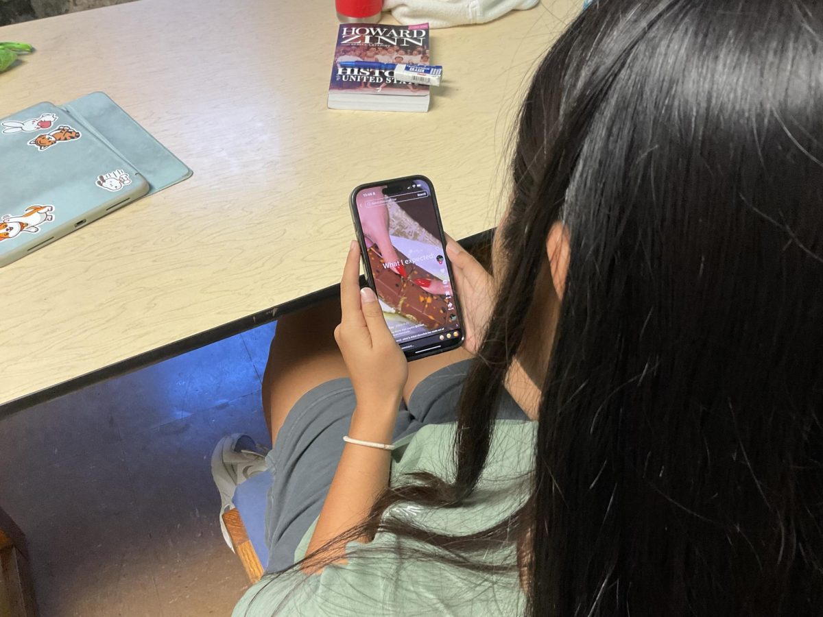 Student on Phone Watching TikTok Trend